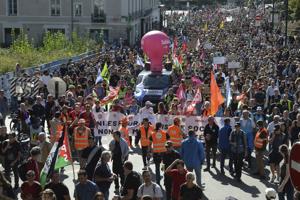 Strikes and protests roil France, pitting the streets against Macron and his new prime minister